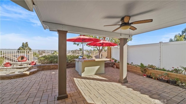 view of patio featuring ceiling fan