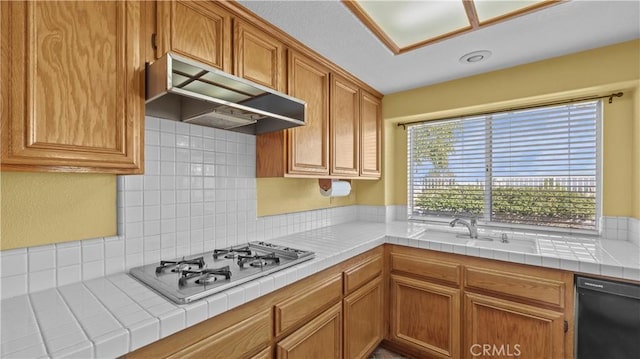 kitchen featuring dishwasher, sink, backsplash, stainless steel gas cooktop, and tile countertops