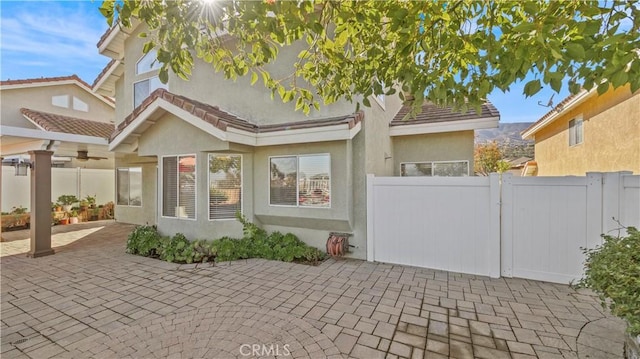 back of house featuring ceiling fan and a patio