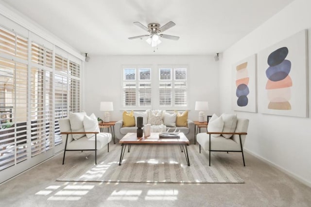 sitting room featuring ceiling fan and carpet floors