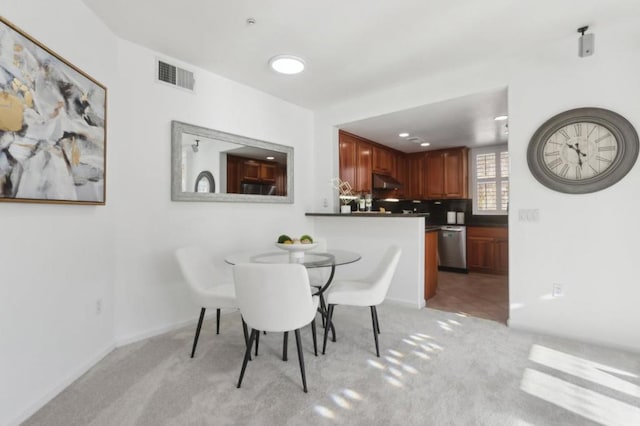 dining room featuring light colored carpet