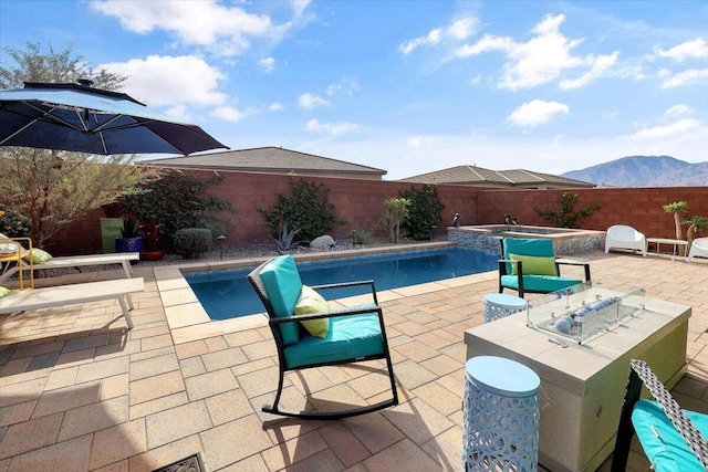 view of swimming pool with a mountain view, a patio area, an in ground hot tub, and an outdoor bar