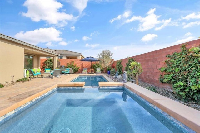 view of swimming pool with an in ground hot tub and a patio