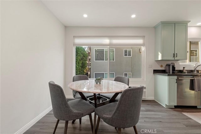 dining space featuring light wood-type flooring and sink