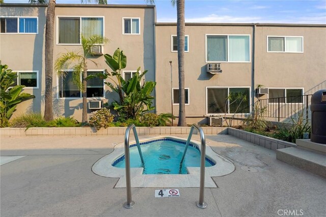 view of pool featuring an in ground hot tub