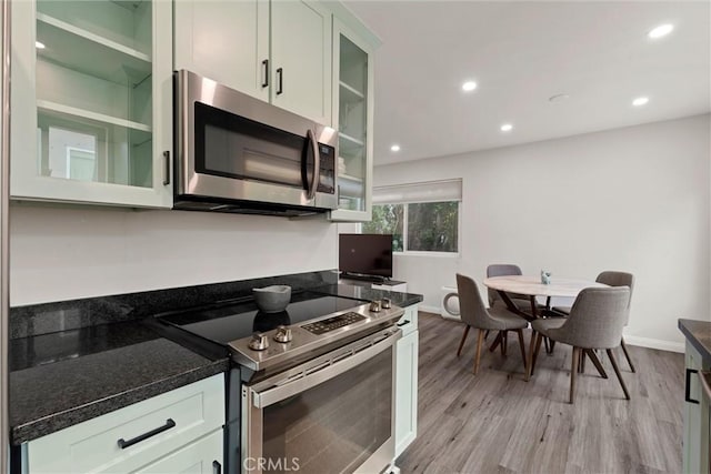 kitchen featuring white cabinets, stainless steel appliances, and light hardwood / wood-style floors