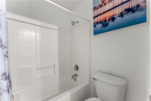 bathroom with toilet and shower / bath combo with shower curtain