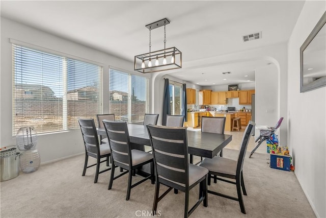 dining space with light colored carpet