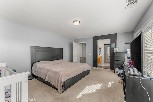 carpeted bedroom with connected bathroom