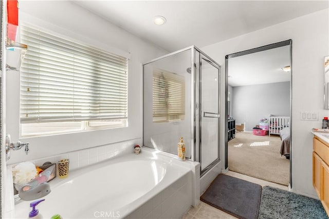 bathroom with tile patterned floors, vanity, radiator heating unit, and independent shower and bath