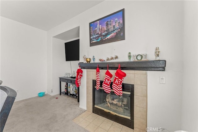 living room featuring a tiled fireplace and carpet