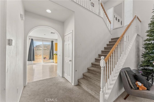 staircase featuring carpet flooring