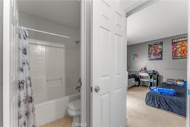 bathroom featuring shower / tub combo and toilet