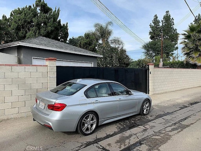 view of vehicle parking with fence