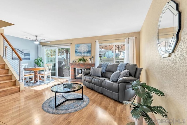 living room featuring ceiling fan and hardwood / wood-style flooring