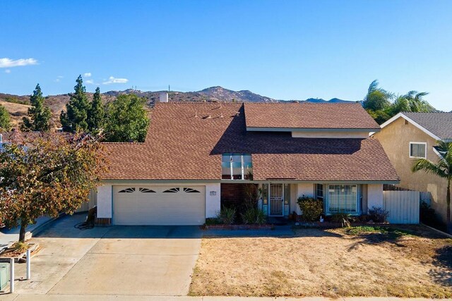 view of front of house with a garage and a mountain view