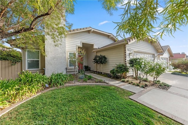 view of front of house featuring a garage and a front lawn