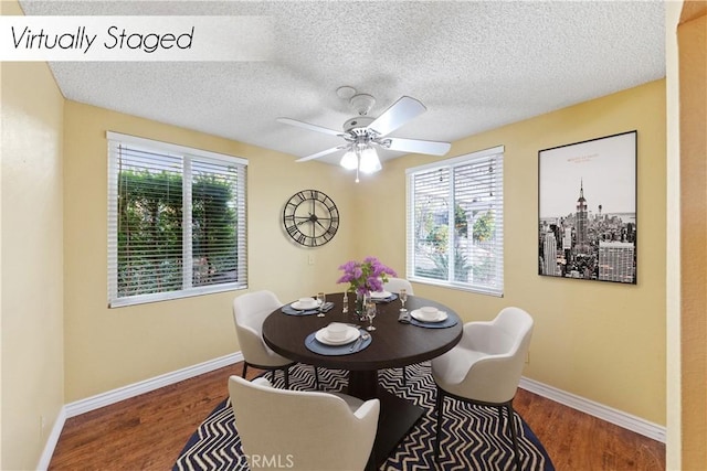 dining room with ceiling fan, dark hardwood / wood-style flooring, a wealth of natural light, and a textured ceiling