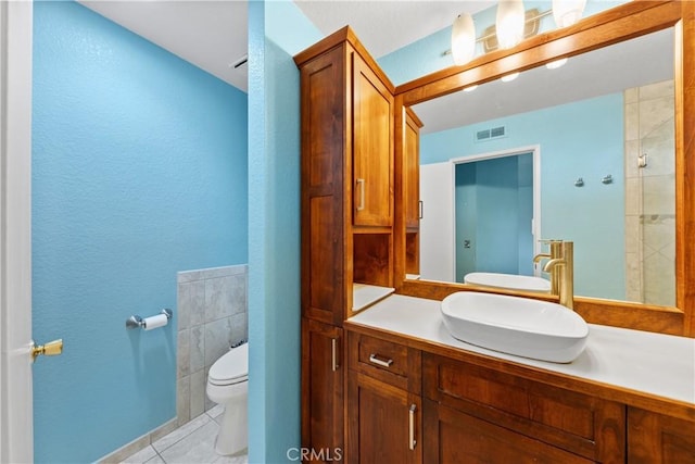 bathroom featuring toilet, tile patterned flooring, and vanity