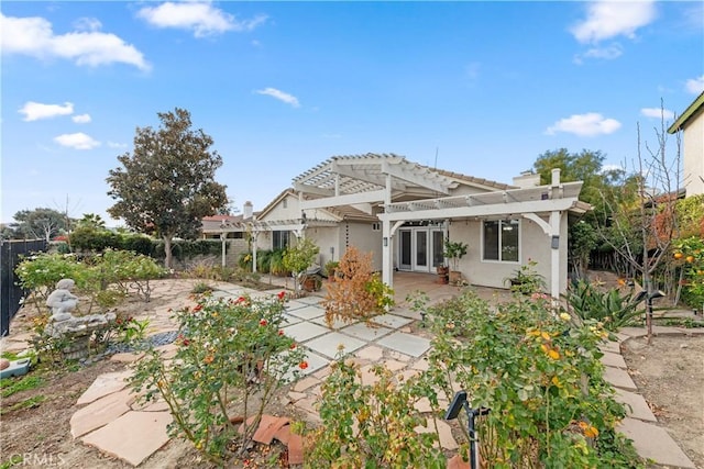 rear view of house featuring a pergola and a patio area