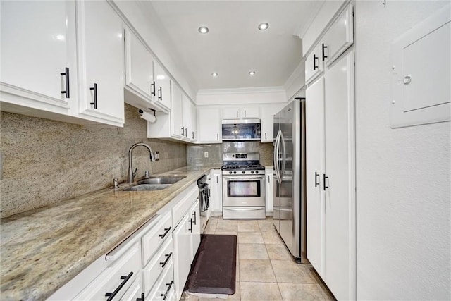 kitchen with light tile patterned floors, appliances with stainless steel finishes, light stone countertops, white cabinets, and sink