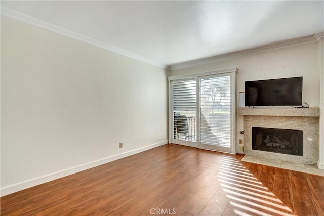 unfurnished living room with crown molding and wood-type flooring