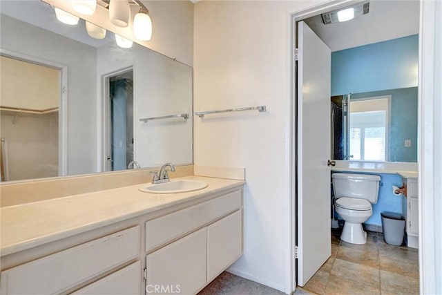 bathroom with toilet and vanity