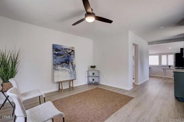 sitting room with ceiling fan and light hardwood / wood-style floors