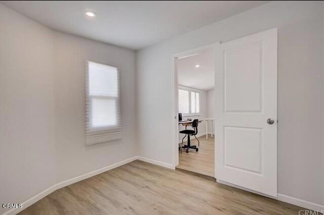 spare room featuring light hardwood / wood-style flooring