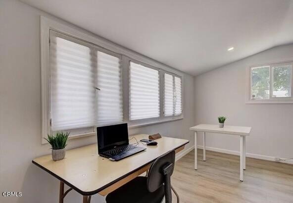 office area featuring vaulted ceiling and light hardwood / wood-style floors