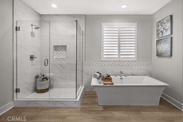 bathroom with wood-type flooring and plus walk in shower