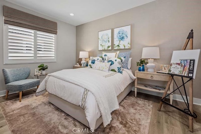 bedroom with hardwood / wood-style floors