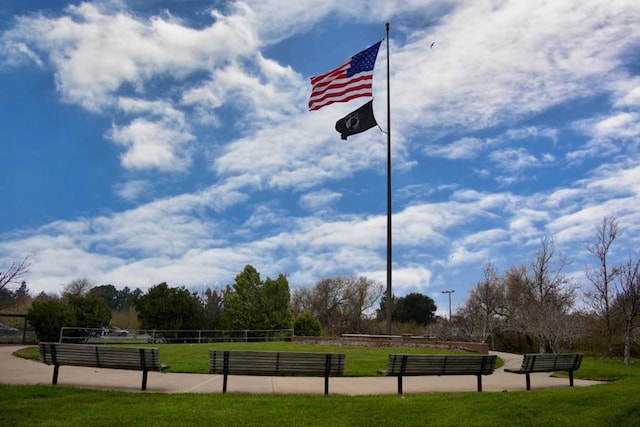 view of property's community with a lawn