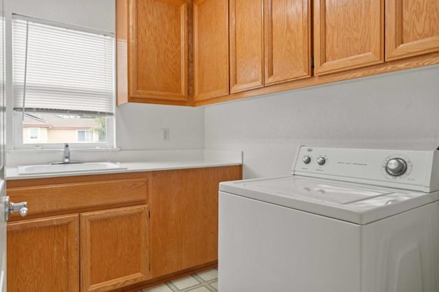 laundry room featuring cabinets, washer / clothes dryer, and sink