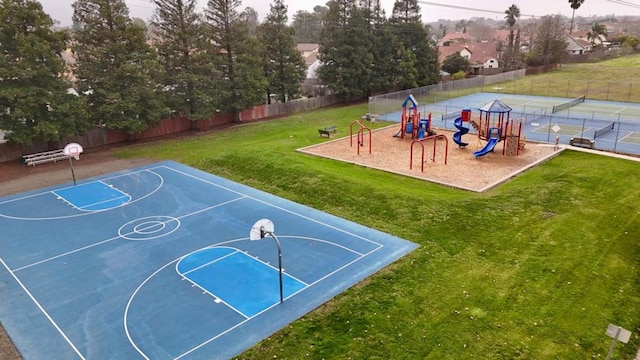 view of basketball court featuring a yard and a playground