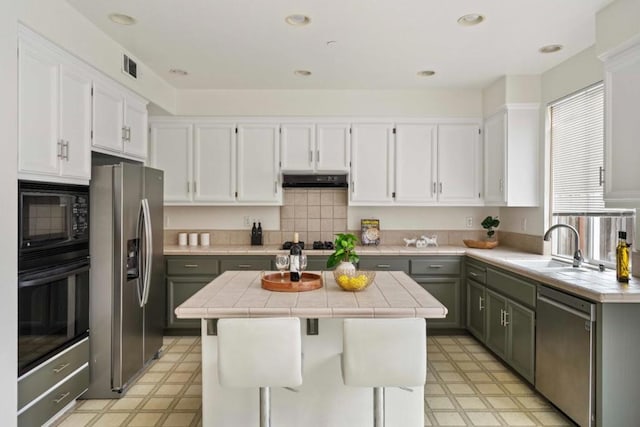 kitchen with gray cabinets, white cabinetry, black appliances, and a center island