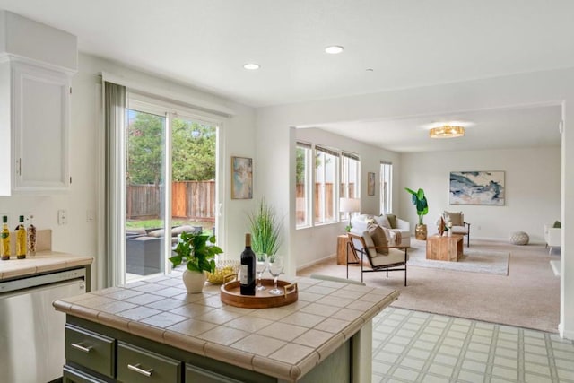 interior space featuring bar and light colored carpet