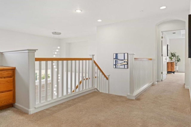 hall featuring light colored carpet