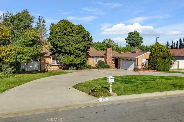 view of front of home with a front yard and a garage