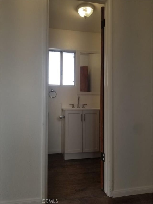 31072 Azurite Rd, Lucerne Valley, CA 92356 - bathroom featuring baseboards, wood finished floors, and vanity