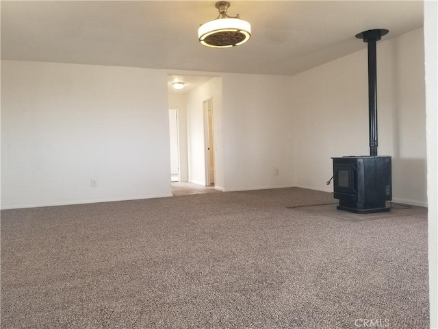 31072 Azurite Rd, Lucerne Valley, CA 92356 - unfurnished living room with a wood stove and carpet