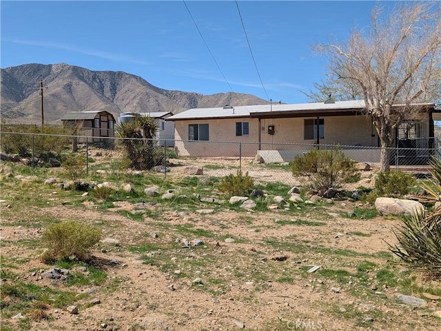 31072 Azurite Rd, Lucerne Valley, CA 92356 - back of property featuring stucco siding, a mountain view, and fence