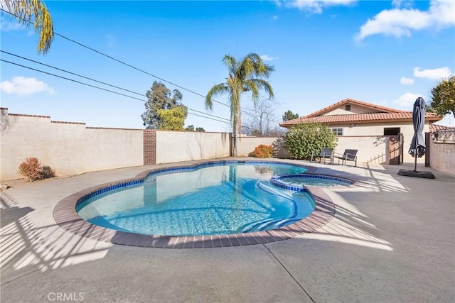 view of swimming pool with a patio area and an in ground hot tub