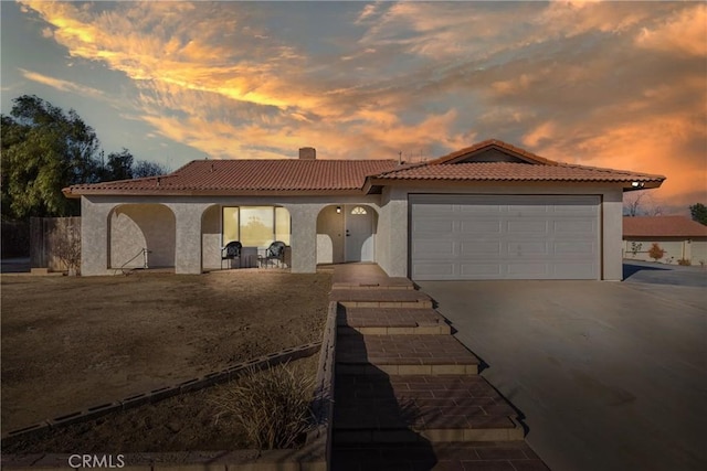 mediterranean / spanish-style house with a garage