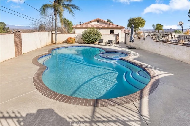 view of pool with a patio and an in ground hot tub