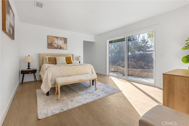 bedroom with light hardwood / wood-style floors and access to outside