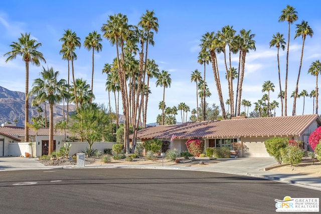 view of front facade with a garage and a mountain view