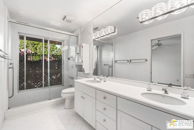 bathroom featuring toilet, a shower with shower door, ceiling fan, tile patterned flooring, and vanity