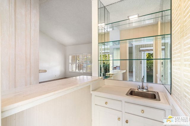 bar featuring white cabinetry and sink