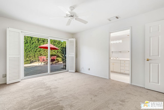 spare room featuring ceiling fan and light carpet